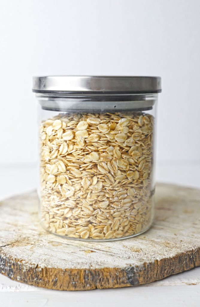 side shot of rolled oats stored in a glass jar with the lid
