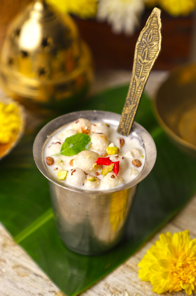 side shot of Panchamrit served in a silver glass with a spoon