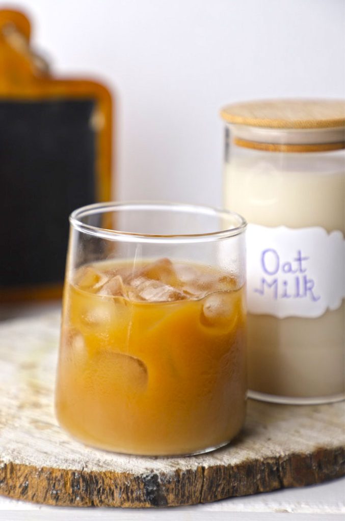 side shot of iced coffee with oat milk