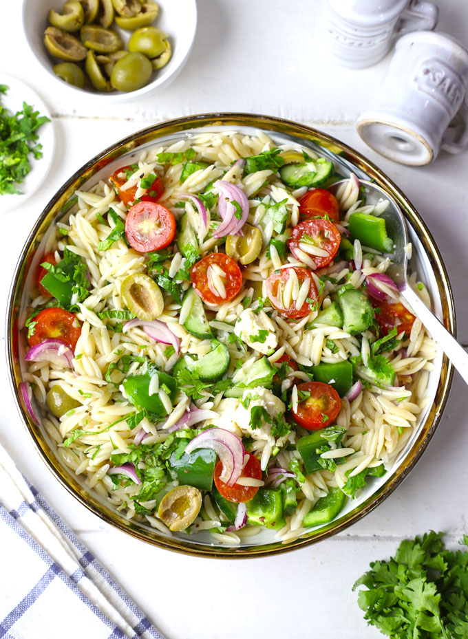 aerial shot of Greek orzo pasta salad in a white bowl