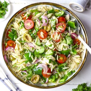 aerial shot of Greek pasta salad in a white bowl