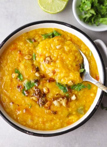 aerial shot of masoor dal in a white ceramic bowl with spoon