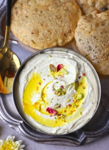 aerial shot of Shrikhand with poori in a platter