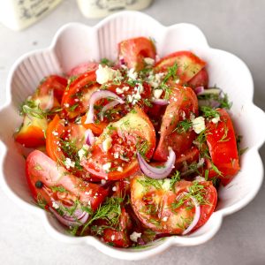 aerial shot of tomato salad in a white ceramic bowl