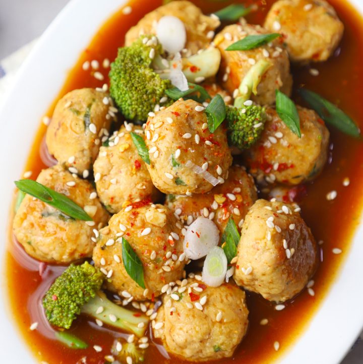side close up shot of Asian chicken meatballs in a white platter