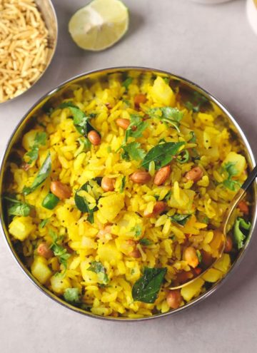 aerial shot of kanda poha in a stainless steel platter