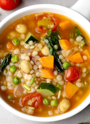 aerial shot of tomato couscous soup in a white ceramic bowl