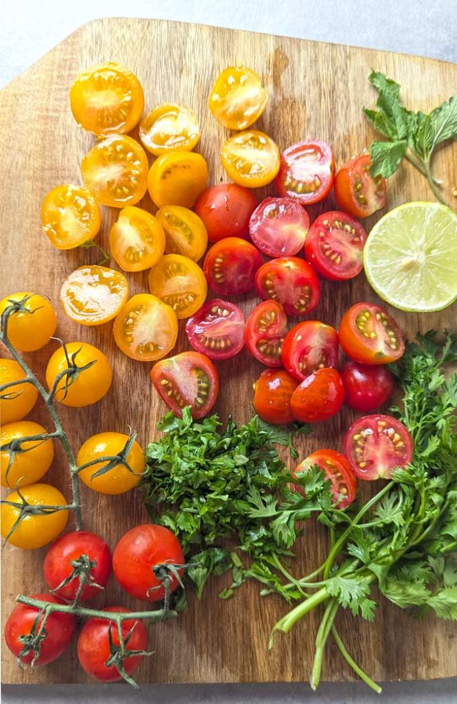 aerial shot of cherry tomatoes with herbs