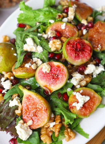 aerial close up shot of roasted fig salad on a white platter