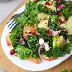 close up side shot of kale apple salad in a white platter