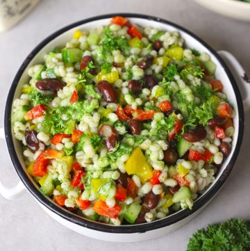 aerial shot of green barley salad in a white ceramic bowl