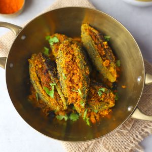 aerial shot of bharwa karela in a brass platter