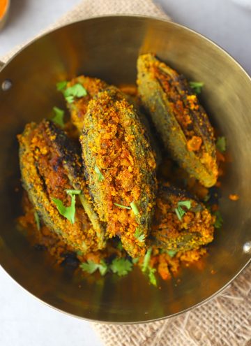 aerial shot of bharwa karela in a brass platter
