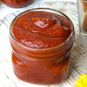 side close up shot of tomato ketchup in a glass jar