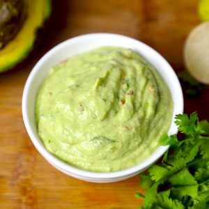 side close up shot of avocado sauce in a bowl.