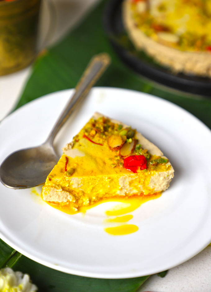 side close up shot of bhapa doi slice served on a white plate.
