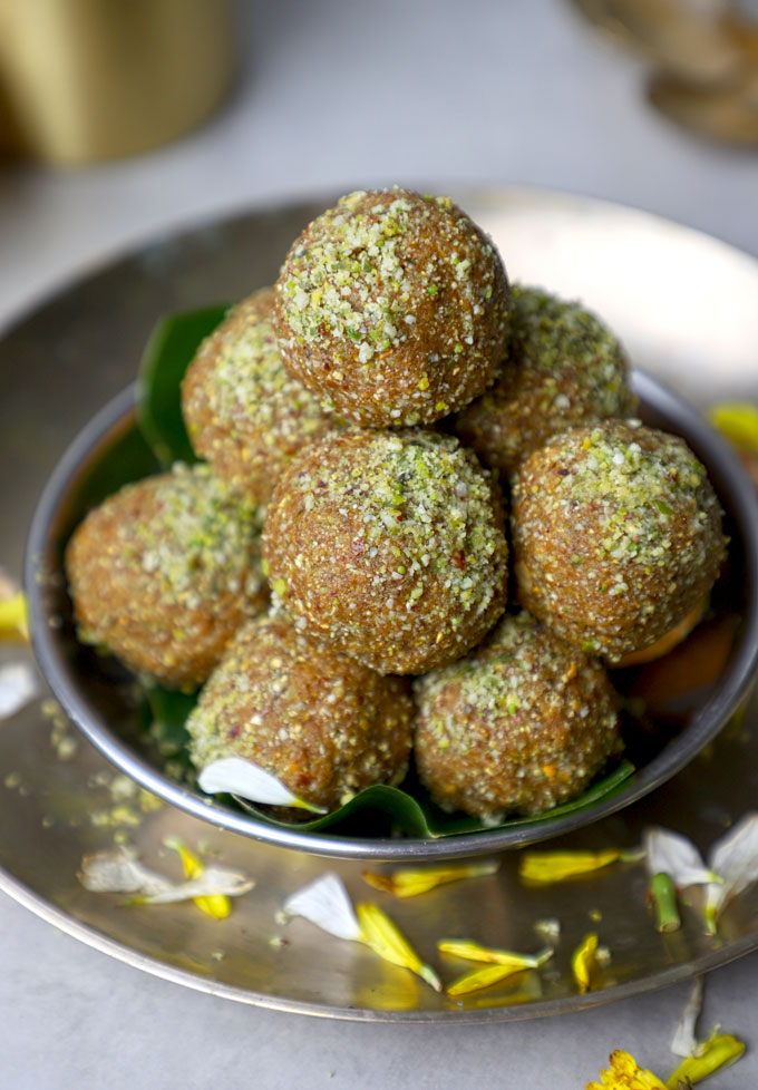 side close up shot of sattu ke laddu stack on a stainless steel plate.