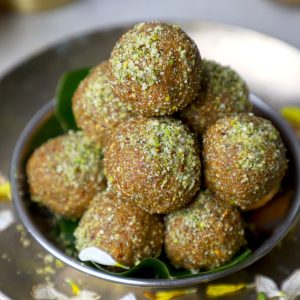 side close up shot of sattu ke laddu stacked in a stainless steel bowl.