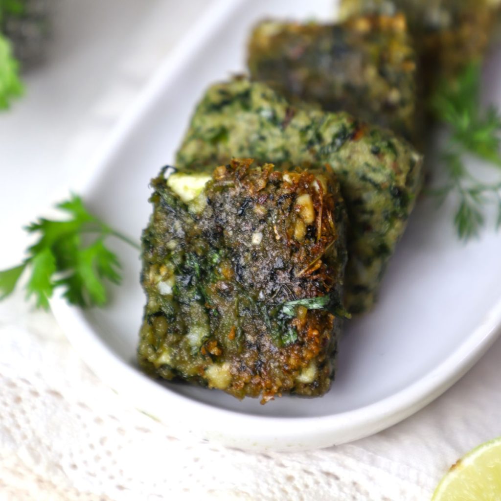 side close up shot of thecha paneer in a white platter.
