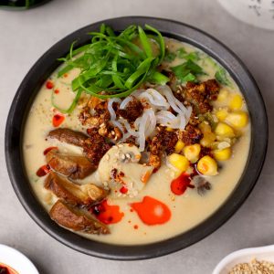 aerial side shot of peanut butter ramen in a black ceramic bowl.