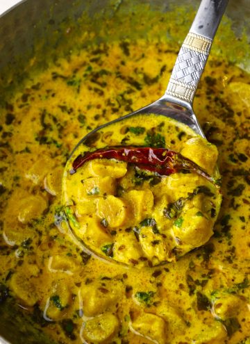 close up shot of gatte ki sabzi in a kadhai.