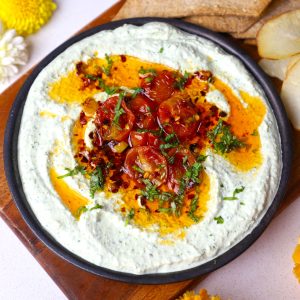 aerial shot of whipped paneer dip served in a black platter.