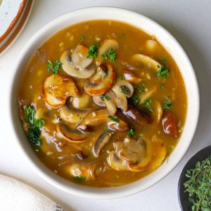 aerial shot of mushroom gravy served in a cream bowl.