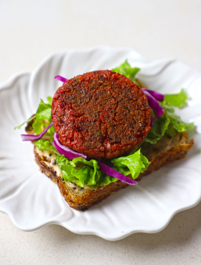 side shot of soya cutlet served on bread with lettuce. - 12