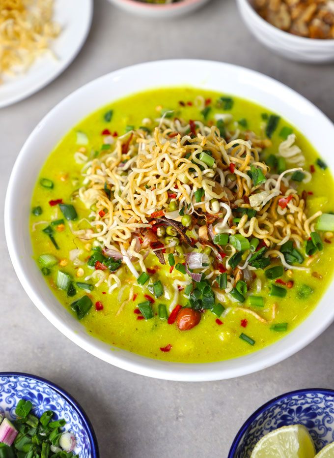 side close up shot of Burmese khao suey in a white ceramic bowl.