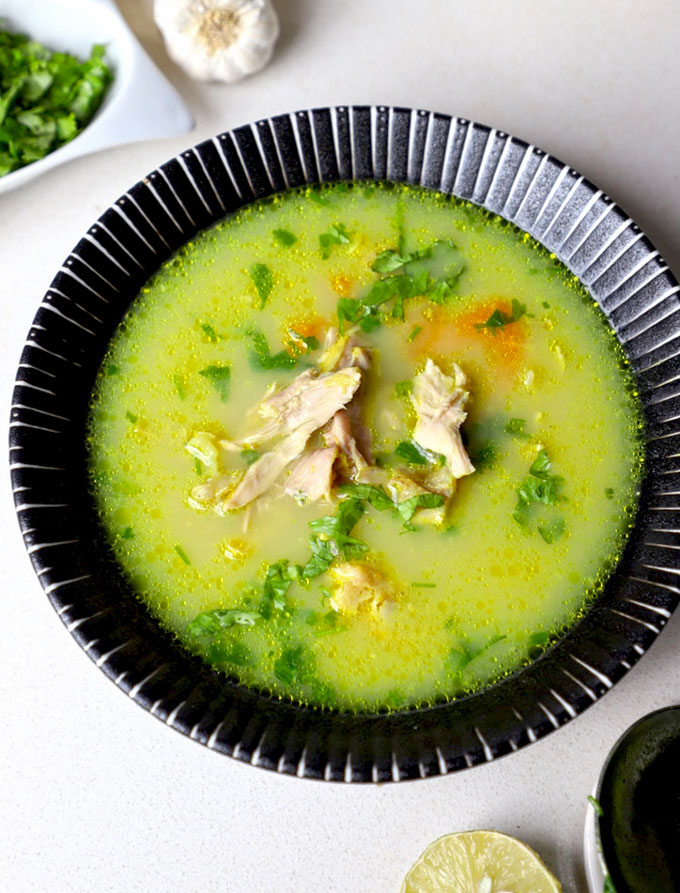 aerial close up shot of chicken shorba in a black ceramic bowl. - 15
