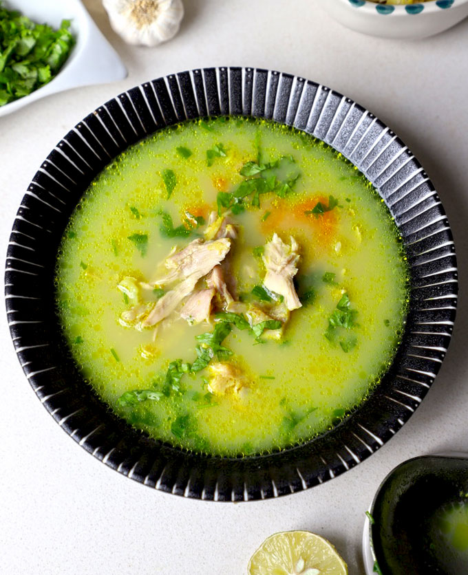 aerial shot of chicken shorba in a black ceramic bowl. - 26