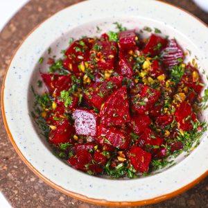 side close up shot of beetroot salad in a ceramic bowl. - 13
