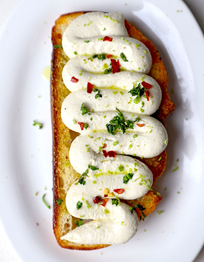 aerial shot of whipped tofu toast served on a white ceramic platter. - 1