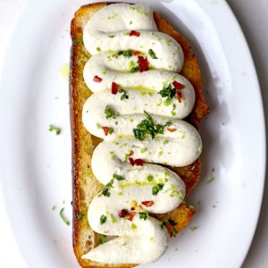 aerial shot of whipped toafu toast served on a white platter. - 10