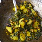 side close up shot of methi aloo in a cast iron kadhai. - 13