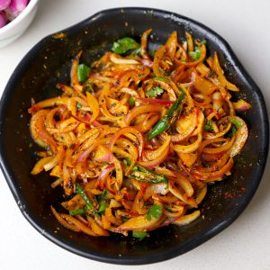 aerial shot of onion pickle served in a black bowl. - 8