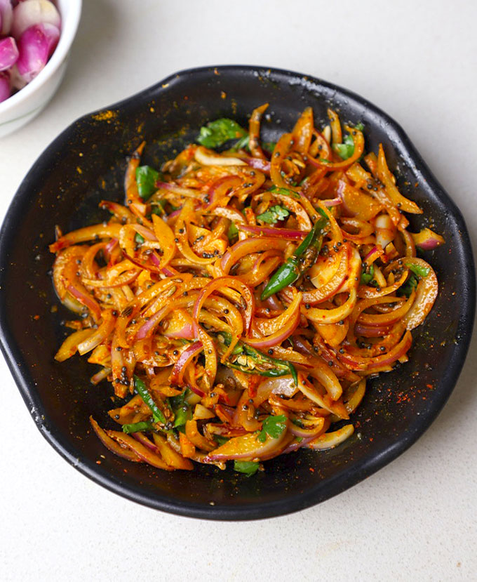 aerial shot of onion pickle in a black bowl. - 7