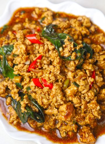 side close up shot of Thai basil chicken served in a white platter.