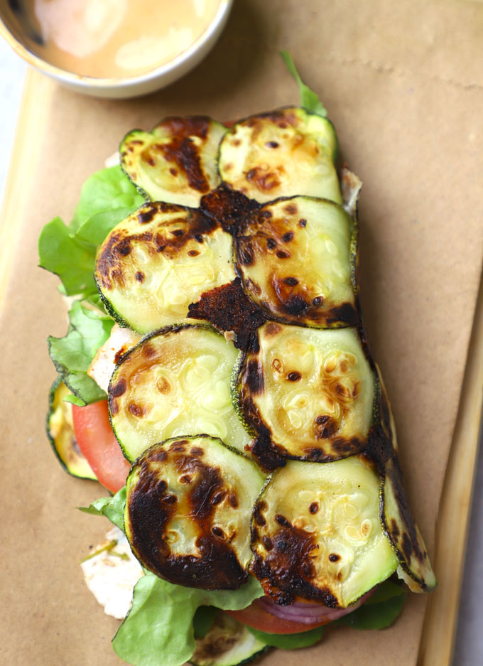 aerial shot of zucchini wrap served on a brown platter. - 7