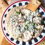 aerial shot of caramelized onion dip served with crackers.