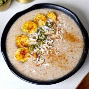 aerial shot of amaranth porridge served in a black bowl.