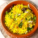 aerial close up shot of mango rice in an earthen pot.