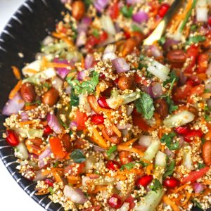 side close up shot of puffed amaranth bhel puri in a black, ceramic bowl.