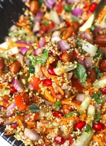 side close up shot of puffed amaranth bhel puri in a black, ceramic bowl.
