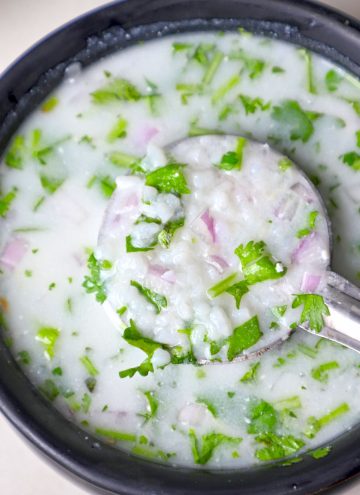 aerial close up shot of rice kanji in a black ceramic bowl.