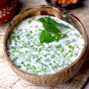 side close up shot of Rajasthani Jau Ki Raab in a coconut glass.