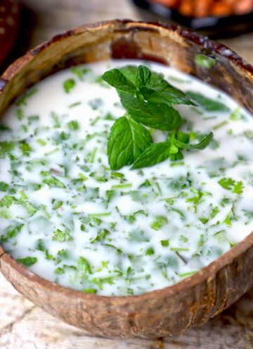 side close up shot of Rajasthani Jau Ki Raab in a coconut glass.