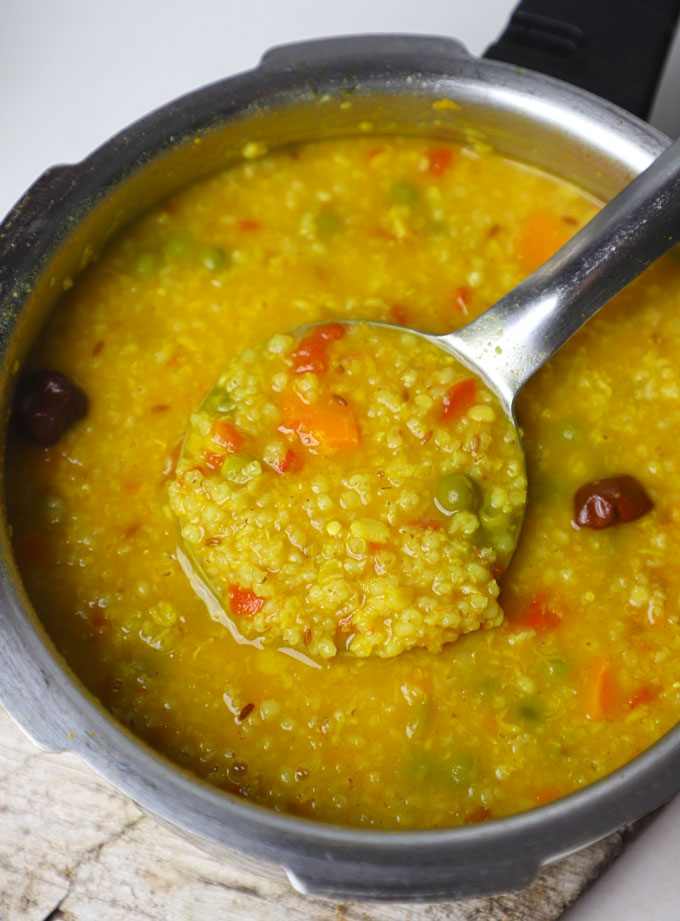 aerial shot of barley khichdi in a pressure cooker.
