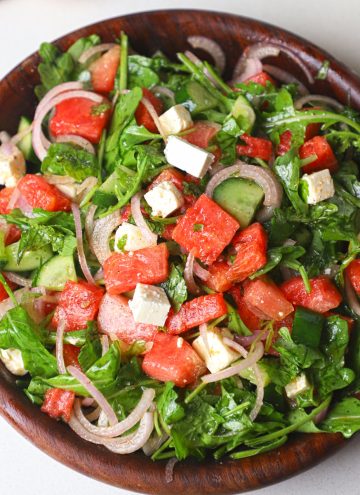 aerial shot of watermelon salad served in a wooden bowl.