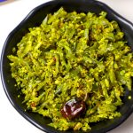 aerial shot of avarakkai poriyal served in a black bowl.